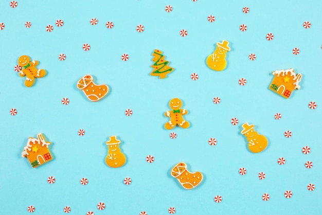 Decorative winter pattern from various gingerbread cookies on blue background