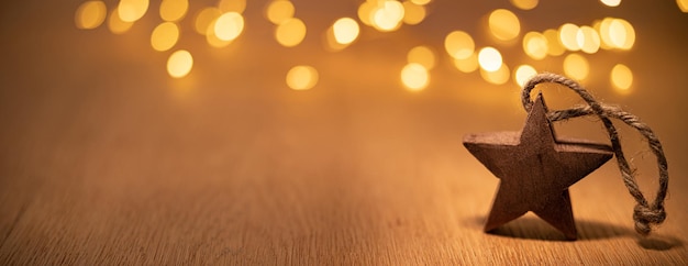 Decorative wooden Christmas star on the background of bokeh lights