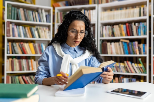 A dedicated student engrossed in reading a book surrounded by a vast collection of literature in a