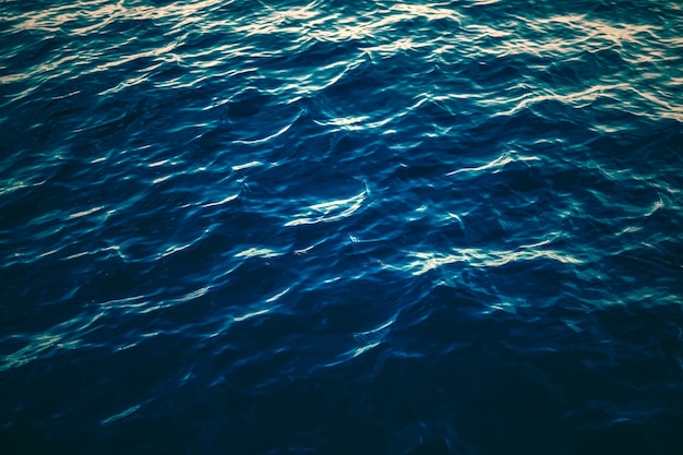 Deep blue ocean water texture dark sea waves background as nature and environmental design