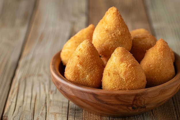 Deep fried croquette serving portion in a wooden background coxinha de frango