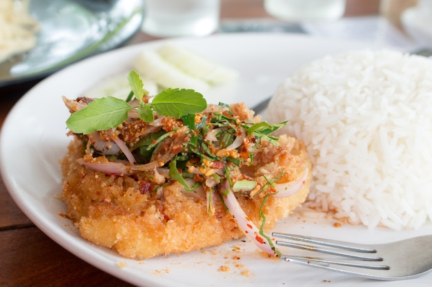 Deep Fried Dolly Fish Steak with sauce Stir basil crispy herb hot and spicy delicious Thai food style