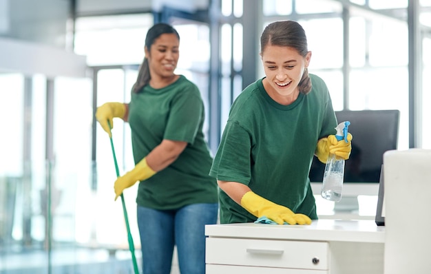 The deepest clean for complete peace of mind Shot of two young woman cleaning a modern office