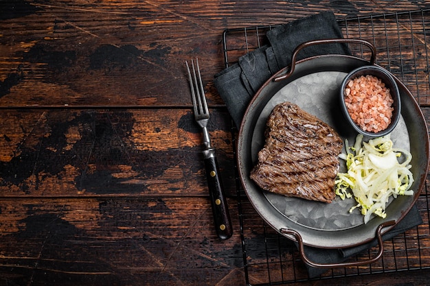 Photo deer venison steak with sea salt and salad wooden background top view copy space