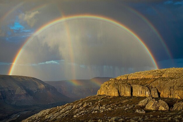 Photo default rainbow over a rocky terrain