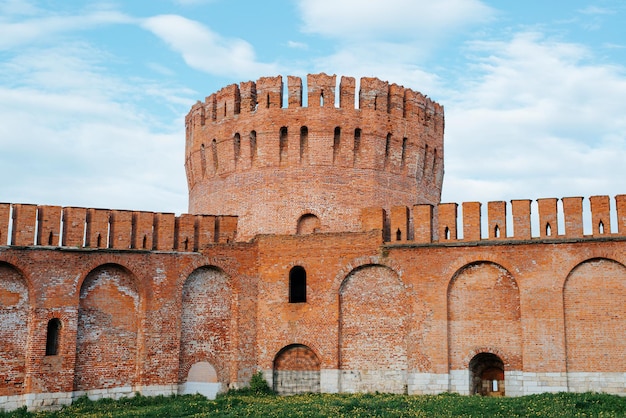 Defensive old building red brick walls and tower Fortress architecture of Middle Ages