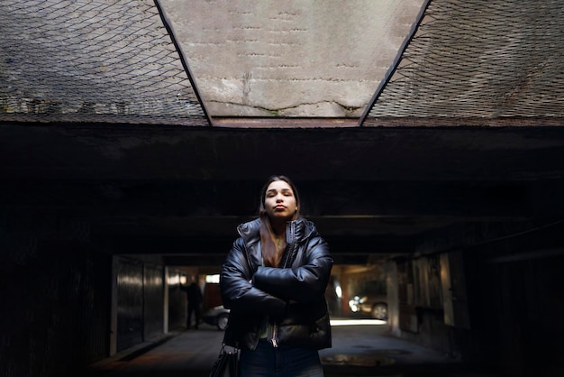 Defiant young woman standing proud in her shelter during the war