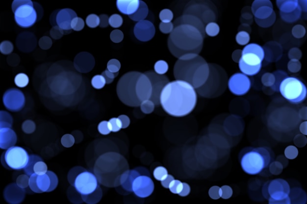 Defocused blue lights on a dark background. Christmas background. bokeh