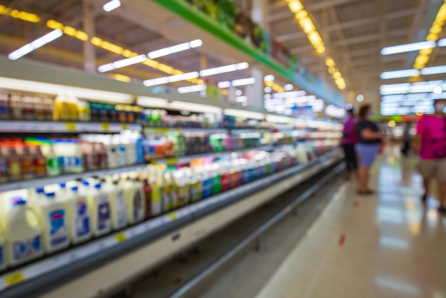 Defocused blur buying milk put on shelf in supermarket for people in for health