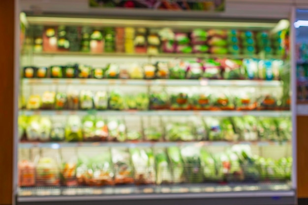 Defocused blur a shopping shelf vegetable and fruit put on them at food supermarket