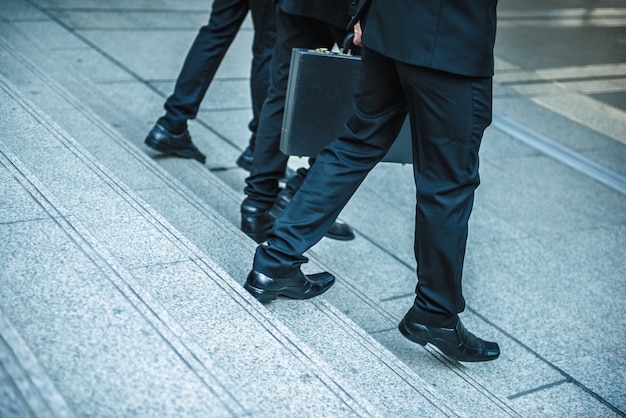 Defocused or blured Businessman walking the stairs with city background, Businessmen go to success concept, vintage style.