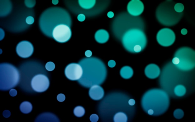 Defocused green and blue lights on a dark background