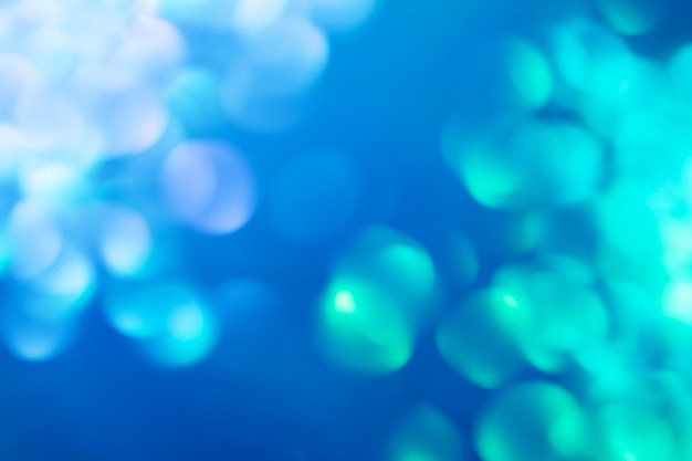 Defocused lights colorful bokeh on blue background for celebration design Abstract blurry backdrop for your design Modern bright holiday background