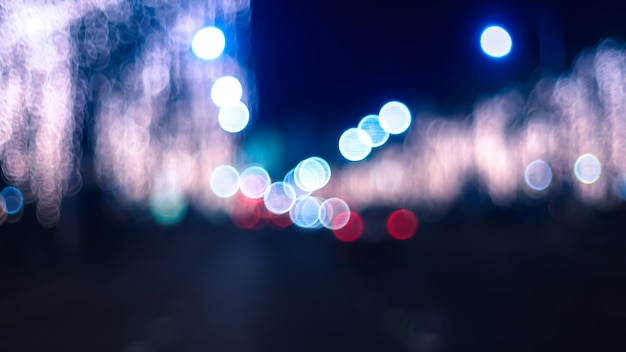 Defocused night Street lights. Bokeh street lights from cars in the city.