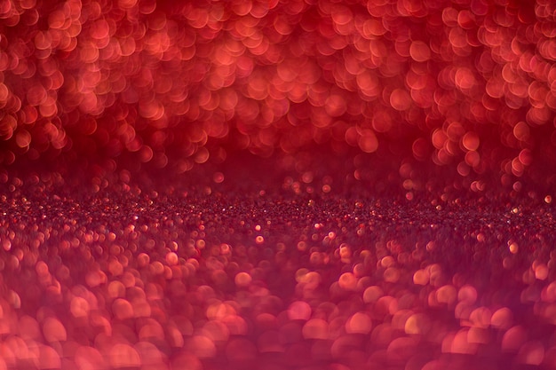 Defocused red glitter background. Abstract bokeh effect