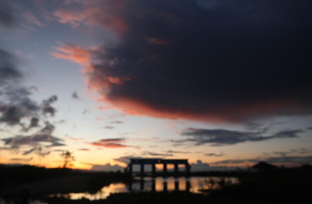 defocused on a silhouette of the sluice in the afternoon against the sunset background