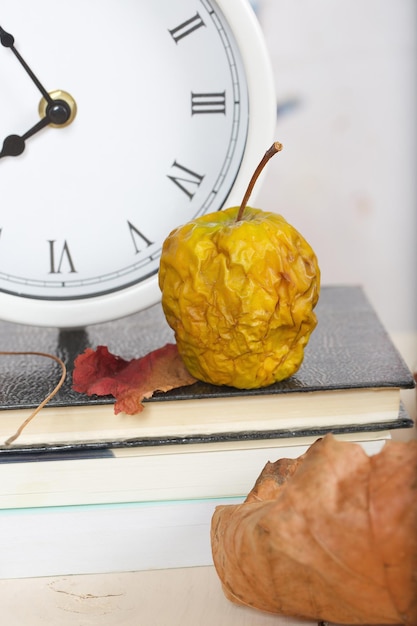 Dehydrated shrivelled green apple on a working table