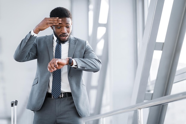 Delayed Flight Businessman Looking At Watch At Airport