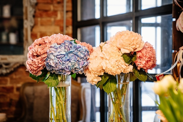 Delicate beautiful flowers from a bouquet in a vase. decoration of the interior.