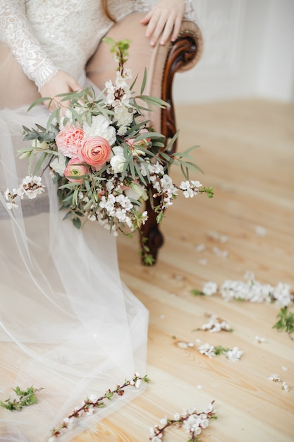 Delicate bouquet with spring flowers and pink ranunculus