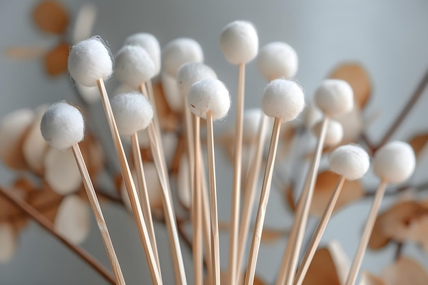 Photo delicate cotton buds on sticks surrounded by natural elements