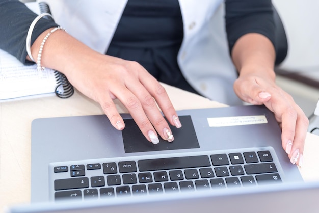 delicate hands of a young woman at a computer secretary receptionist