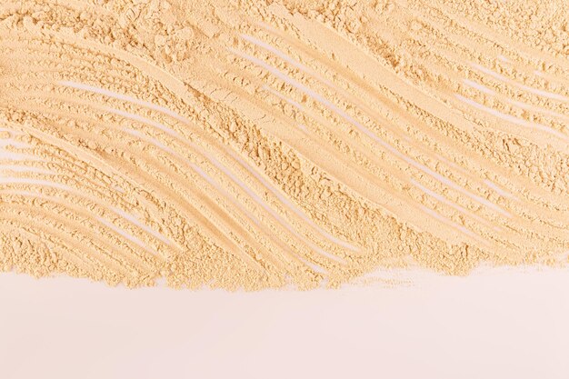 Delicate loose texture of cosmetic powder in a natural tone Closeup view Cosmetic background for design product mockup border