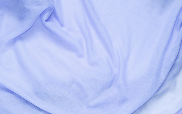 Delicate soft and wrinkled fabric blue color background texture