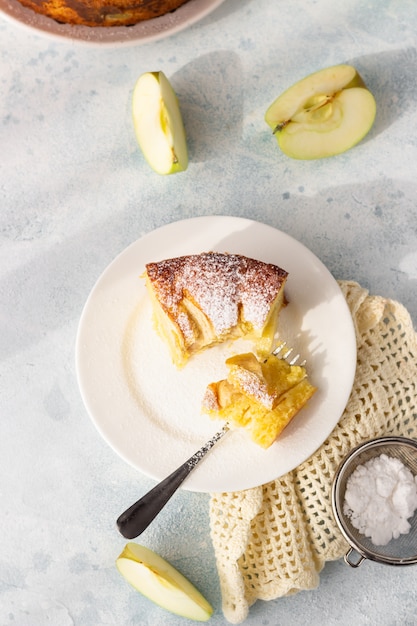 Delicious apple pie or sponge cake decorated with powdered sugar