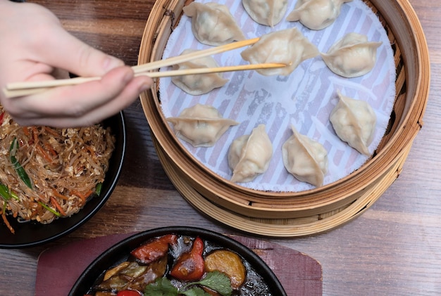 Delicious asian dumplings in bamboo steamer on wooden background Selective focus Asian food concept