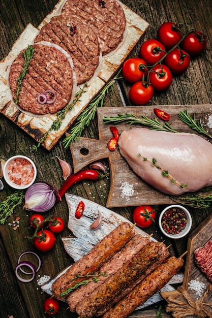 Delicious assortment of raw meat products, different parts of the body. minced beef meat kebabs, pork, beef, chicken. banner, menu, recipe, top view