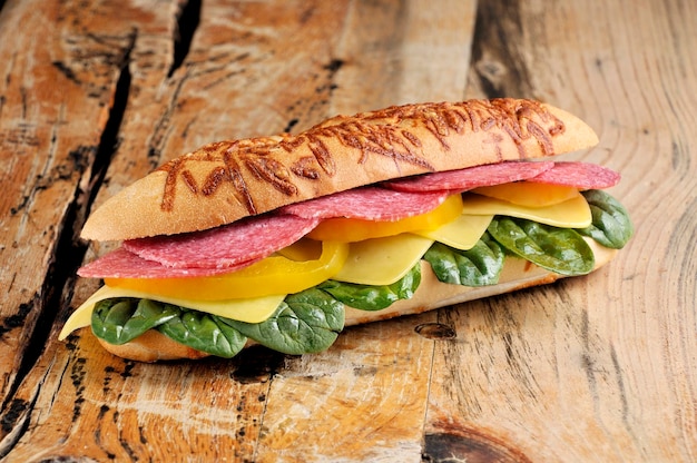 Delicious baguette sandwich with salami and cheese