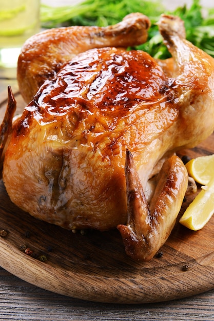 Delicious baked chicken on table close-up