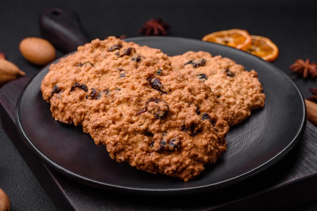 Delicious baked oatmeal raisin cookies on a dark concrete background