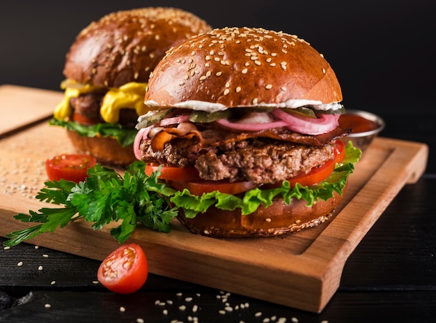 Delicious beef burgers on a wooden board