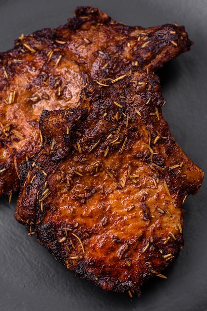 Delicious beef or pork steak on the bone grilled with spices and rosemary