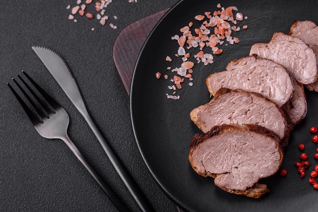 Delicious beef steak with salt spices and herbs on a ceramic plate