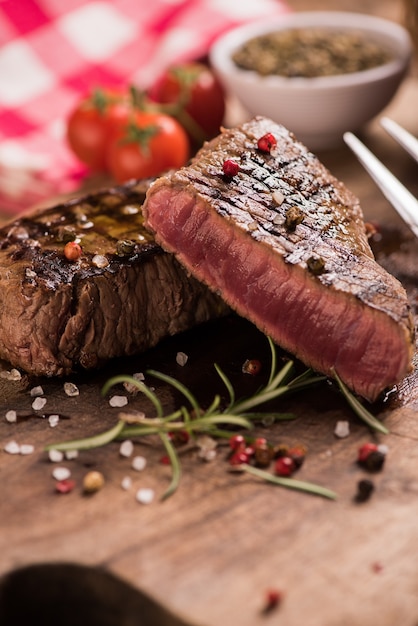 Delicious beef steak on wooden table, close-up