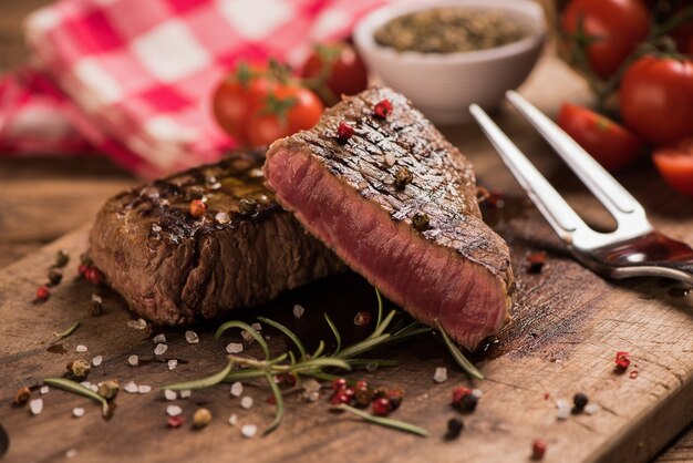 Delicious beef steak on wooden table, close-up