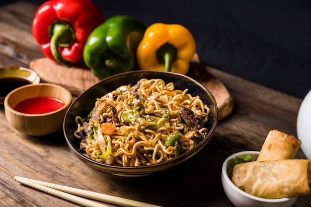 Delicious beef teriyaki with udon noodles and sesame seed garnish on wooden desk