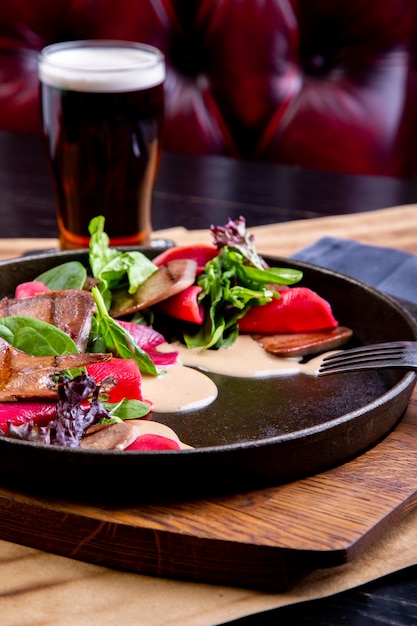 Delicious beef tongue with spinach and beetroot in restaurant