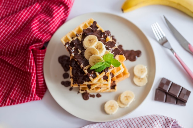 delicious belgian waffles for breakfast with banana and chocolate