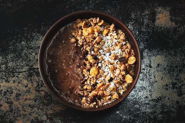 Delicious breakfast bowl with chocolate yogurt and granola. Healthy breakfast.