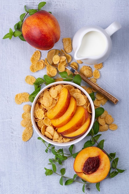 A delicious Breakfast cereal with milk and peach