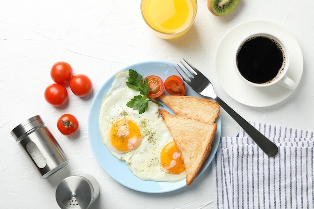 Delicious breakfast or lunch with fried eggs on white table, top view