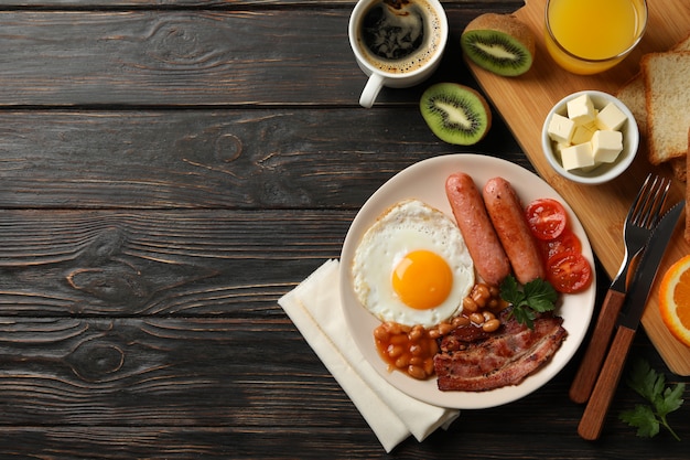 Delicious breakfast or lunch with fried eggs on wooden table, top view