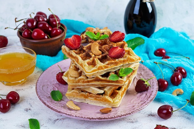 Delicious breakfast with belgian waffles Waffels with strawberry and berry jam