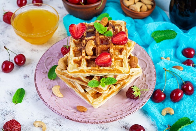 Delicious breakfast with belgian waffles Waffels with strawberry and berry jam