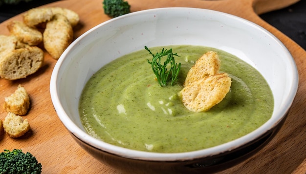 Delicious broccoli cream soup with parmesan cheese and crunchy croutons Healthy vegetarian food Vegan menu Top view copy space