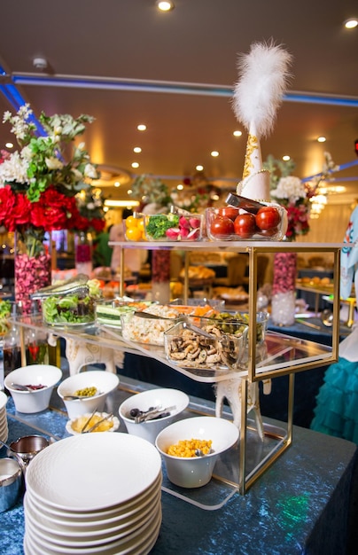 Delicious buffet spread with salads vegetables and snacks for events Blue background